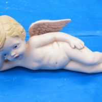 scioto 1551 lying cherub on side,right hand on head 7"L bisqueware
